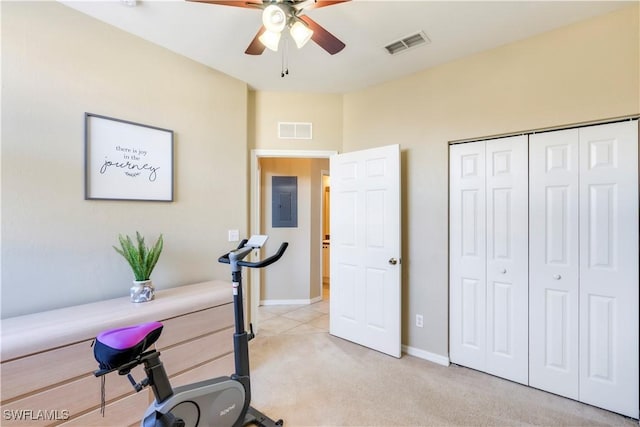 exercise room featuring light carpet, visible vents, electric panel, and a ceiling fan