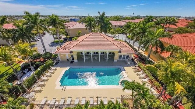 community pool with a patio and fence