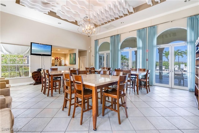 dining space featuring a chandelier, french doors, light tile patterned flooring, and ornamental molding