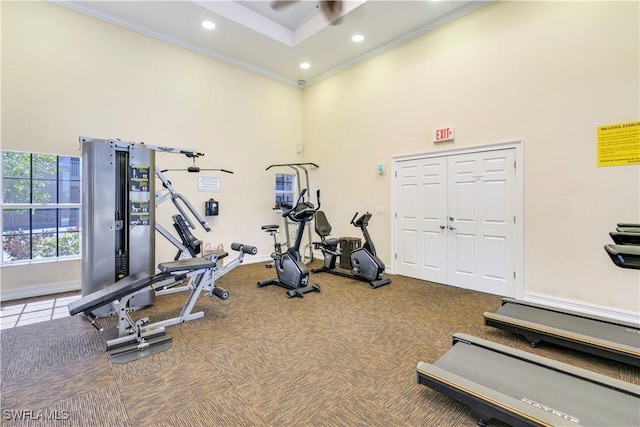 exercise room with recessed lighting, a high ceiling, ornamental molding, and carpet flooring