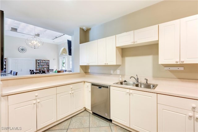 kitchen featuring a sink, stainless steel dishwasher, white cabinets, and light countertops