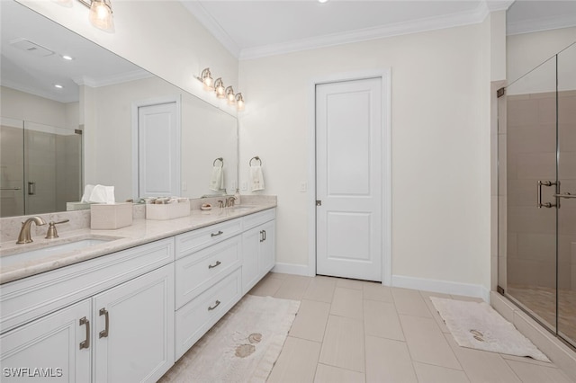 bathroom with a shower stall, ornamental molding, baseboards, and a sink