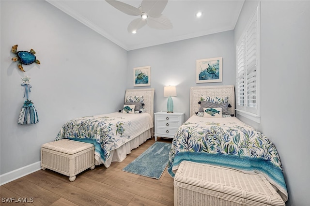 bedroom featuring a ceiling fan, wood finished floors, baseboards, recessed lighting, and crown molding