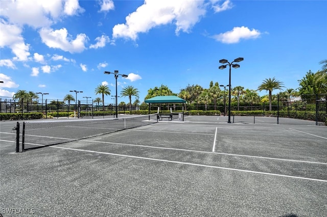 view of tennis court featuring fence