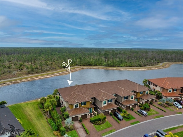 birds eye view of property featuring a residential view, a forest view, and a water view