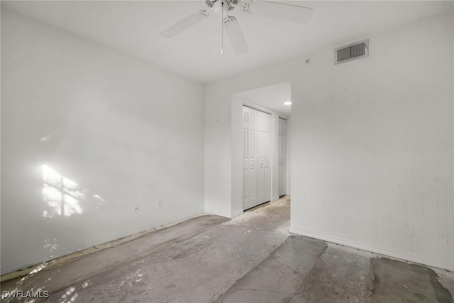 empty room with ceiling fan and visible vents