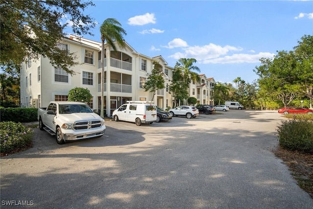 view of building exterior featuring uncovered parking