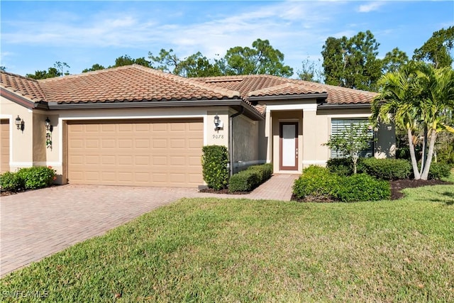 mediterranean / spanish-style home with a tile roof, a front yard, stucco siding, decorative driveway, and an attached garage