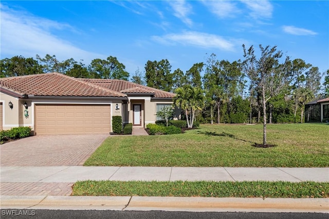 mediterranean / spanish-style house with a front lawn, a tile roof, stucco siding, decorative driveway, and an attached garage