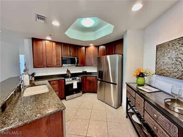 kitchen featuring a raised ceiling, visible vents, appliances with stainless steel finishes, light tile patterned flooring, and a sink