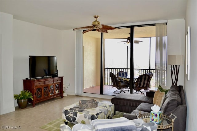 living room with expansive windows, ceiling fan, and light tile patterned floors