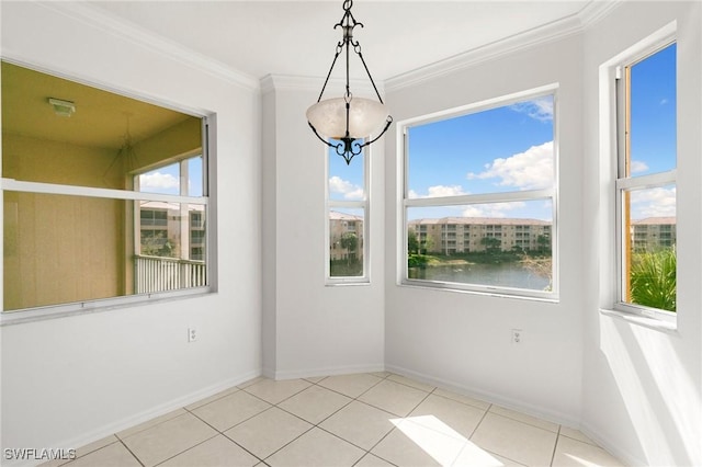 unfurnished dining area with tile patterned floors, baseboards, and crown molding