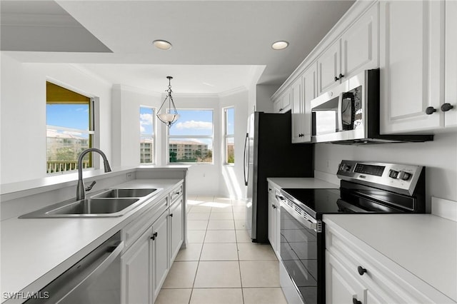 kitchen featuring crown molding, light countertops, appliances with stainless steel finishes, white cabinets, and a sink