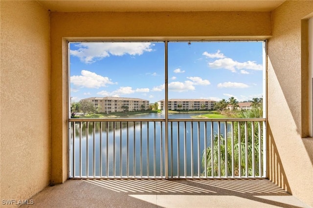 unfurnished sunroom with a water view