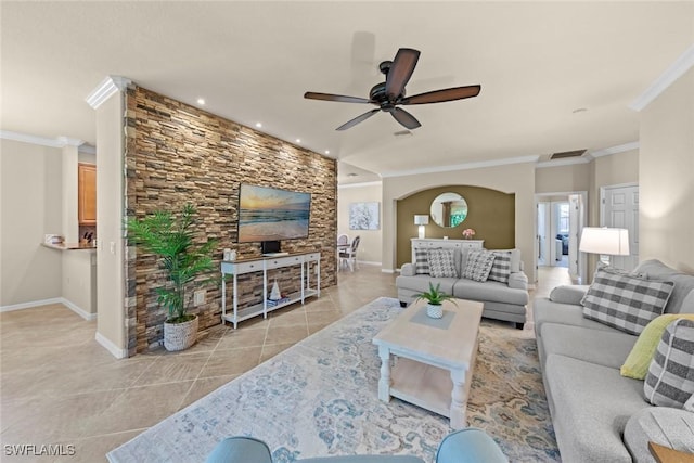 living area with light tile patterned floors, baseboards, a ceiling fan, and crown molding