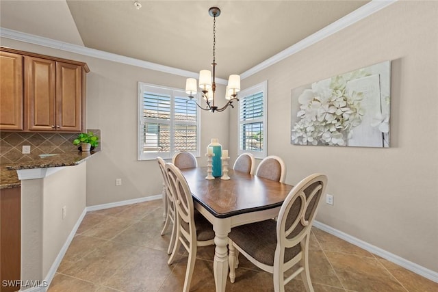 dining area featuring baseboards, a chandelier, light tile patterned flooring, and ornamental molding