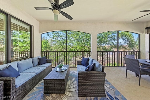 sunroom featuring a ceiling fan