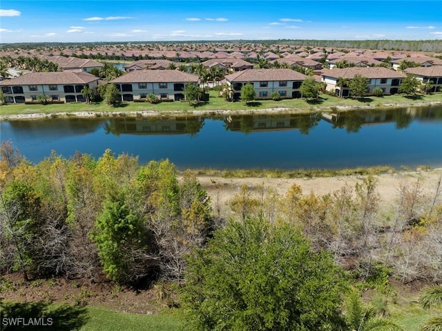 drone / aerial view with a residential view and a water view