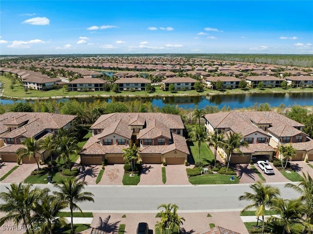 bird's eye view with a residential view and a water view