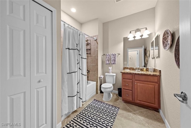 bathroom featuring vanity, tile patterned floors, toilet, and baseboards