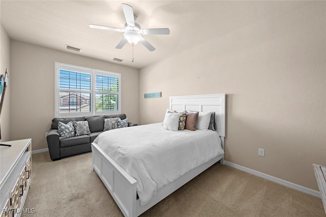 bedroom with light carpet, visible vents, a ceiling fan, and baseboards