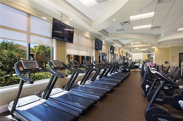 exercise room featuring visible vents, baseboards, and crown molding