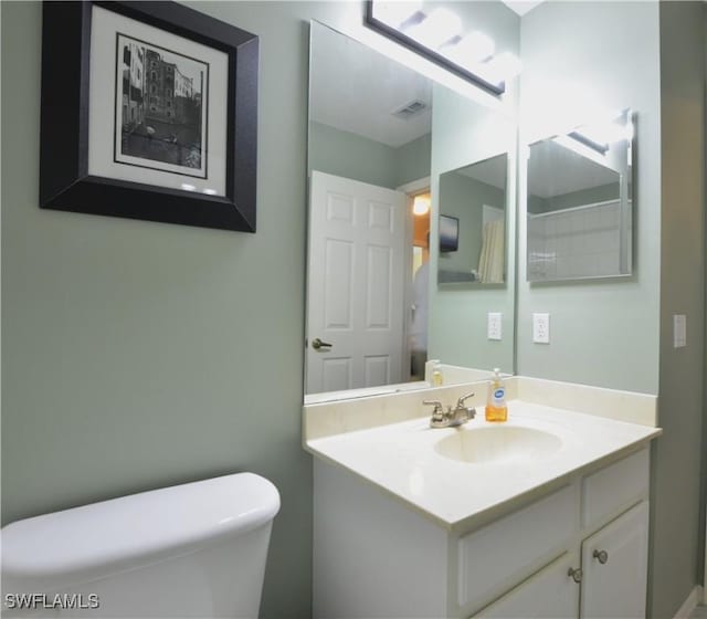 bathroom with visible vents, toilet, and vanity
