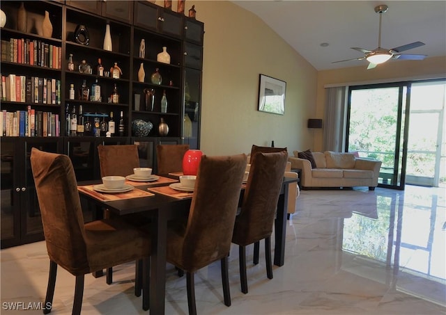 dining area featuring marble finish floor, vaulted ceiling, and a ceiling fan