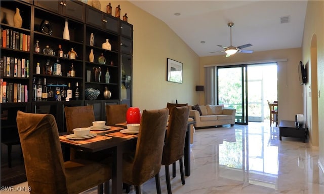 dining area featuring marble finish floor, lofted ceiling, ceiling fan, and visible vents