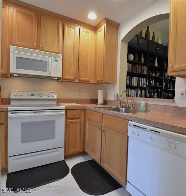 kitchen featuring light countertops, recessed lighting, a sink, and white appliances