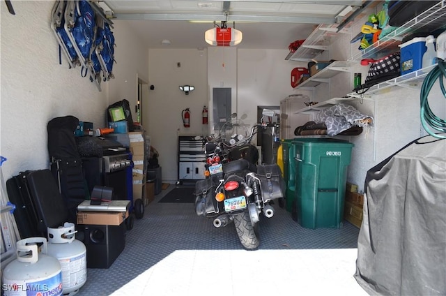 garage featuring electric panel and a garage door opener