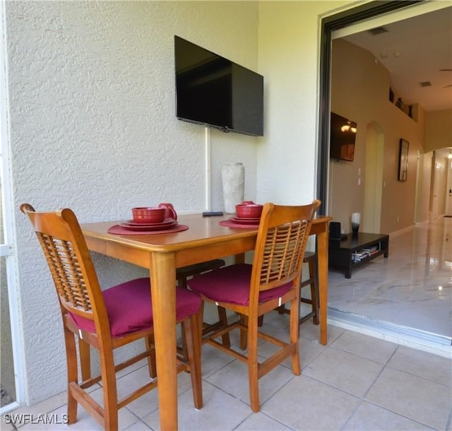 dining space with a textured wall
