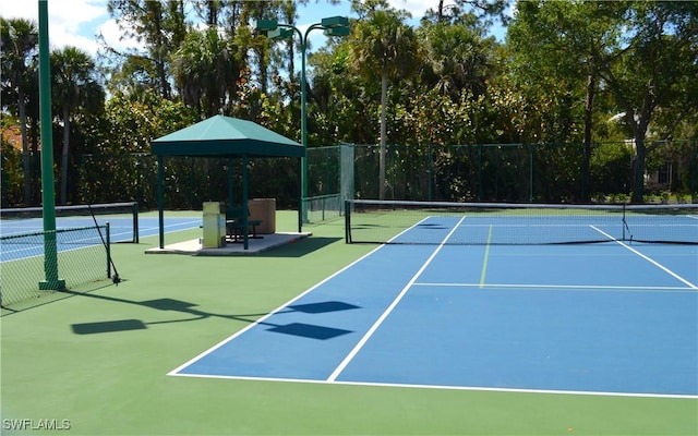 view of tennis court with fence