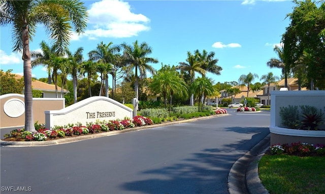 view of road with a residential view and curbs