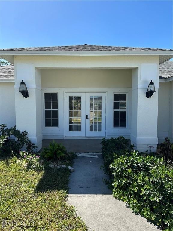 property entrance with french doors and roof with shingles