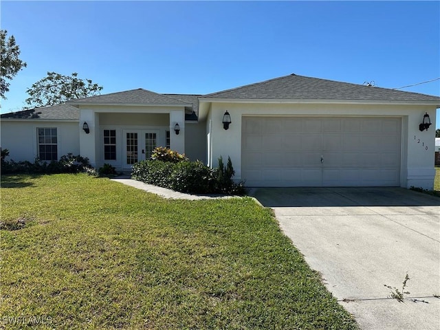 ranch-style home with concrete driveway, an attached garage, french doors, a front yard, and stucco siding