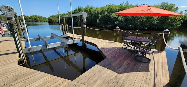 view of dock featuring a water view and boat lift