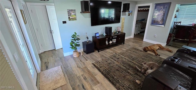 living area with wood finished floors and baseboards