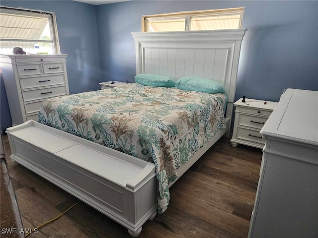 bedroom with dark wood-style flooring