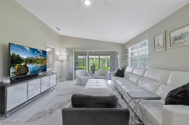 living room featuring visible vents and high vaulted ceiling