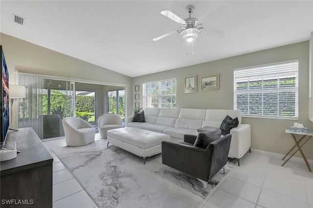 tiled living room featuring lofted ceiling, ceiling fan, visible vents, and baseboards