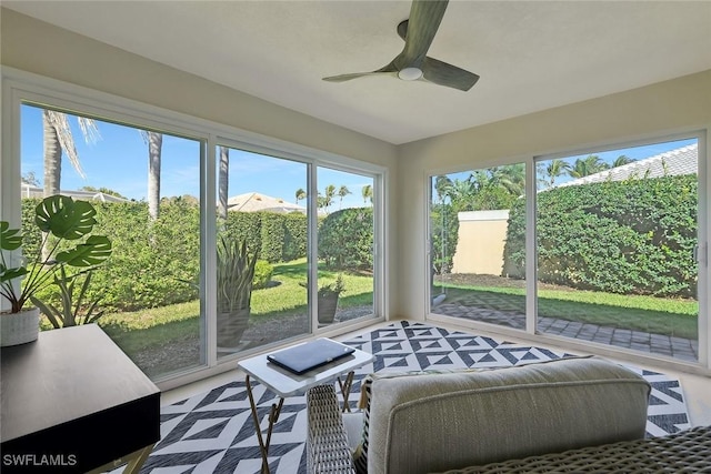 sunroom / solarium featuring ceiling fan