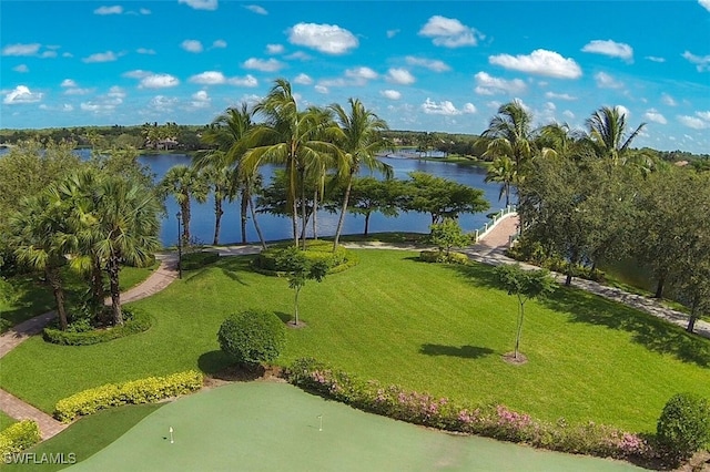 view of property's community with a water view and a yard