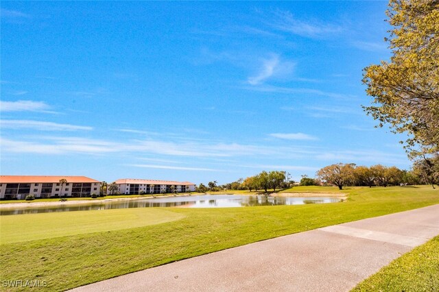 surrounding community featuring a water view and a yard