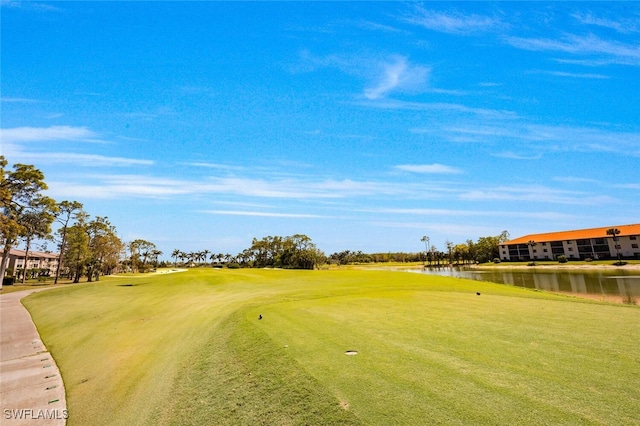 view of property's community with a water view and view of golf course