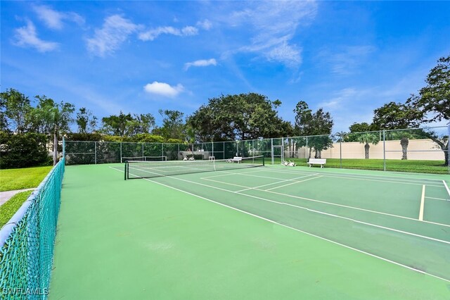 view of sport court featuring fence