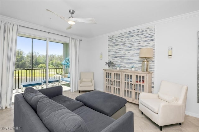 living area with crown molding, light tile patterned floors, an accent wall, a ceiling fan, and baseboards