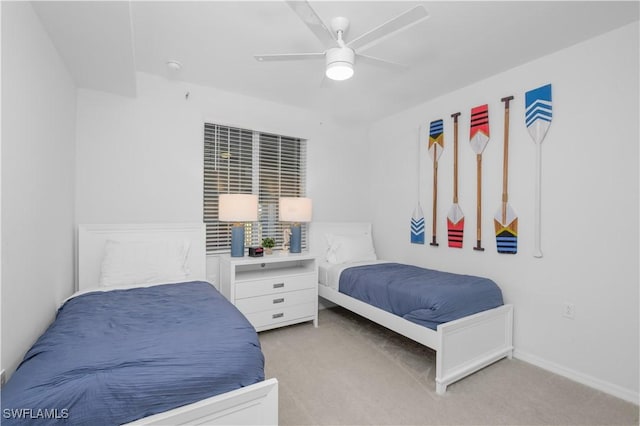 bedroom featuring light carpet, ceiling fan, and baseboards