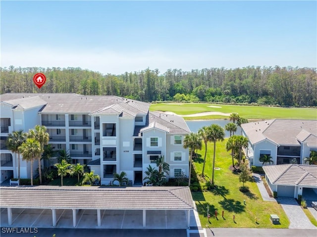 birds eye view of property featuring a view of trees