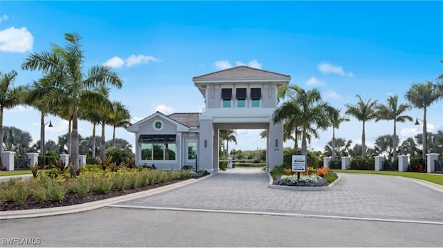view of building exterior with a carport and curved driveway